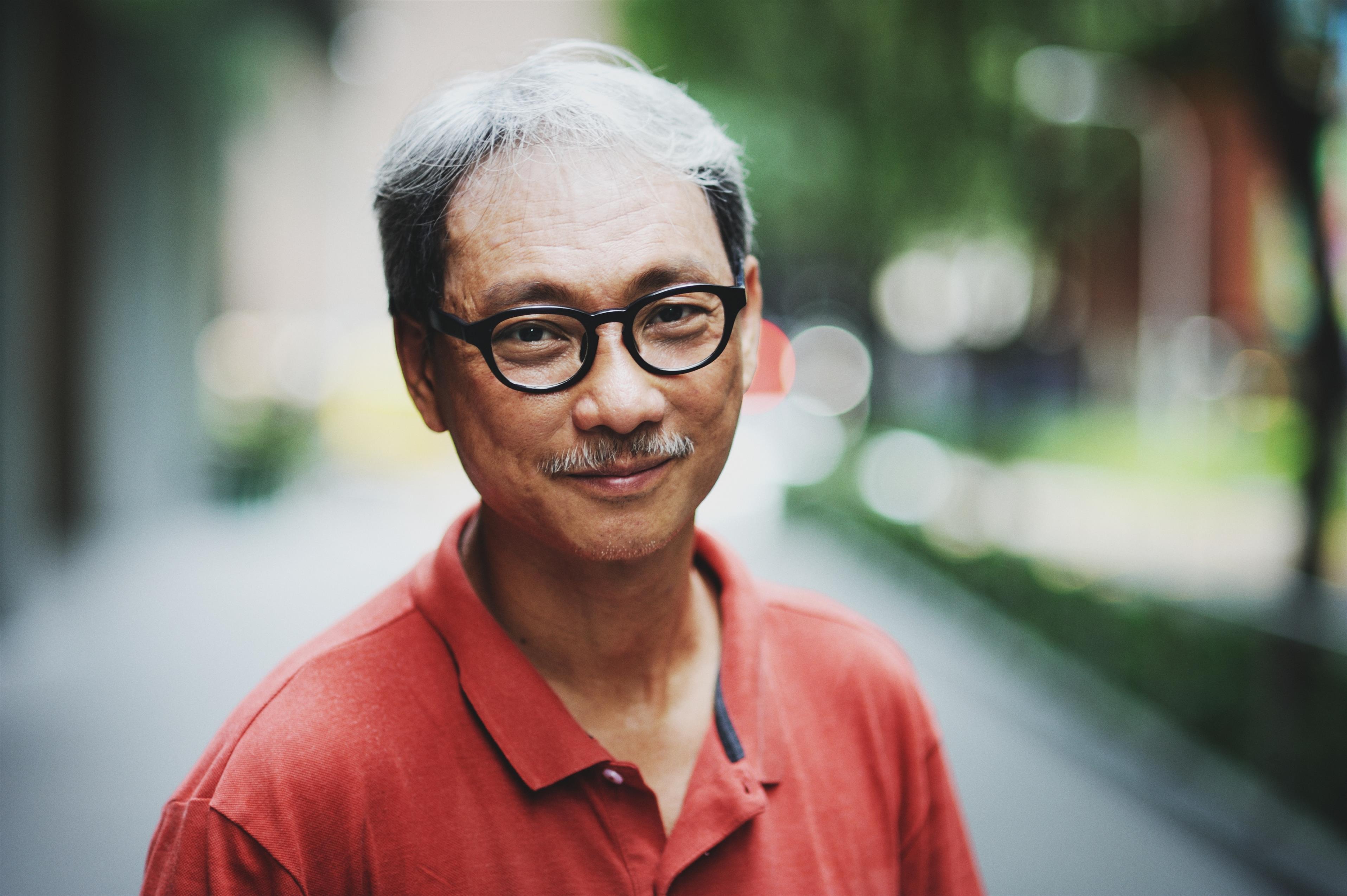 Asian man with glasses in the park